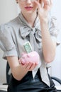 Female hand holding piggy bank. Royalty Free Stock Photo