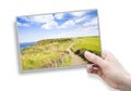 A female hand holding an postcard about Irish landscape with footpath Northern Ireland - United Kingdom