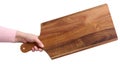 Female hand holding a rectangular wooden cutting board kitchen board Royalty Free Stock Photo