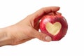 Female hand holding red apple with heart symbol Royalty Free Stock Photo