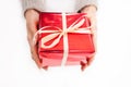 Female hand holding red box present with white bow Royalty Free Stock Photo