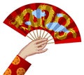Female hand holding a red chinese fan with gold decorative gragon Royalty Free Stock Photo
