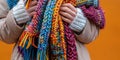 Female hand holding a set of knitted scarf, multi-colored and with different patterns , concept of Textile art Royalty Free Stock Photo