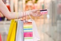 Female hand holding shopping bags and credit card Royalty Free Stock Photo