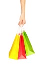 Female hand holding shopping bags, isolated on white background Royalty Free Stock Photo