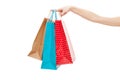 Female hand is holding shopping bags on white background. Copy space. Mock up. Shopping concept Royalty Free Stock Photo