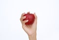 Female hand holding and showing a red apple on white background Royalty Free Stock Photo