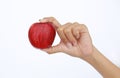 Female hand holding and showing a red apple on white background Royalty Free Stock Photo