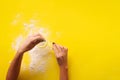 Female hand holding sieve flour on yellow background. Baking and cooking concept. Banner with copy space Royalty Free Stock Photo