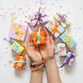Female hand holding a small gift. Gift wrapped in paper. Small g Royalty Free Stock Photo