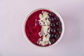 Female hand holding smoothie bowl with acai, banana, blueberries, kiwi fruit and black currants. Healthy super food with fresh Royalty Free Stock Photo