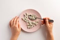 Female hand holding spoon with dietary supplements. Plate with dietary supplements Royalty Free Stock Photo