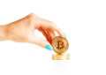 Female hand holding stack of gold bitcoins. Royalty Free Stock Photo