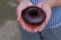 Female hand holding a Sweet donut, dessert