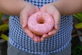 Female hand holding a Sweet donut, dessert