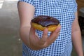 Female hand holding a Sweet donut, dessert