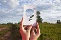 Female hand holding a symbol of gender equality against the background of blue sky with clouds