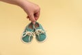 Female hand holding tiny baby shoes. Newborn concept. Royalty Free Stock Photo