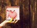 Female hand holding valentine heart on brown vintage studio background, copy space Royalty Free Stock Photo