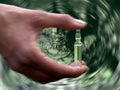 Female hand holding a vial of medicine