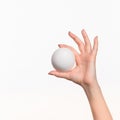 The female hand holding white blank styrofoam ball