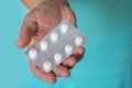 A female hand holding white pills Royalty Free Stock Photo