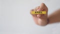 Female hand holding wooden block of calendar with month April