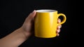 Female hand holding a yellow mug of unlabeled coffee.