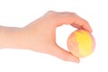 Female hand holding a yellow pink bath ball Royalty Free Stock Photo