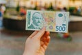 Female hand holds a banknote of 500 five hundred Serbian dinars on a street in the city Royalty Free Stock Photo