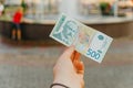 Female hand holds a banknote of 500 five hundred Serbian dinars on a street in the city Royalty Free Stock Photo