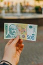 Female hand holds a banknote of 500 five hundred Serbian dinars on a street in the city Royalty Free Stock Photo