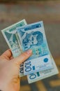 Female hand holds banknotes of 500 five hundred and 100 one hundred Serbian dinars on a street in the city Royalty Free Stock Photo