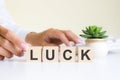 the word LUCK, spelt on wooden cubes with letters over a white background Royalty Free Stock Photo