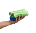 Female hand holds a bundle of blue and green plastic bags for garbage Royalty Free Stock Photo