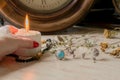 female hand holds a burning candle on a light natural background. pagan wiccan, slavic traditions. Witchcraft, esoteric spiritual