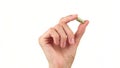 Female hand holds in fingers capsule superfoods moringa or spirulina