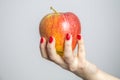 Female hand holds fresh apple