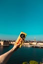 Female hand holds licorice chocolate on a background of a vivid panorama of the city of Stockholm