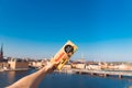 Female hand holds licorice chocolate on a background of a vivid panorama of the city of Stockholm.