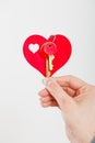 Female hand holds little heart with keys Royalty Free Stock Photo