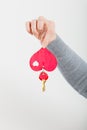 Female hand holds little heart with keys. Royalty Free Stock Photo