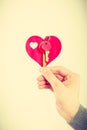 Female hand holds little heart with keys. Royalty Free Stock Photo