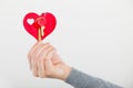 Female hand holds little heart with keys. Royalty Free Stock Photo