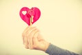 Female hand holds little heart with keys. Royalty Free Stock Photo