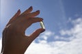 A female hand holds an Omega 3 capsule. Close up. High resolution product.The hand holds the yellow soft shell of the Royalty Free Stock Photo