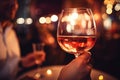 Female hand holds one glass goblet with rose wine. Royalty Free Stock Photo