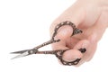 Female hand holds a pair of scissors, isolated on white background