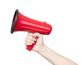 Female hand holds a red megaphone, isolated on white background. File contains a path to isolation. Royalty Free Stock Photo