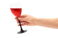 Female hand holds red Wine in glass. Isolated on white background Royalty Free Stock Photo